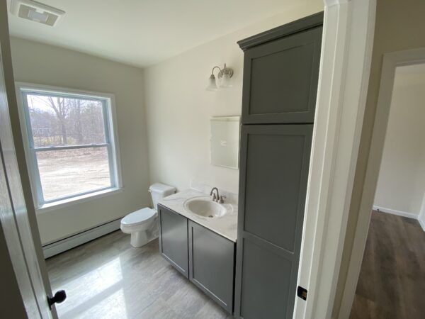 bath with linen cabinet in new modular ranch home project completed by Brookewood Builders, Manchester, ME 04351