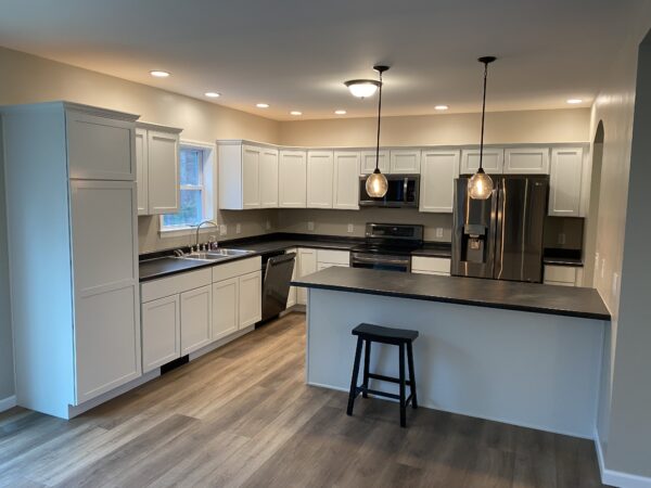 white kitchen with island in new modular ranch home project completed by Brookewood Builders, Manchester, ME 04351