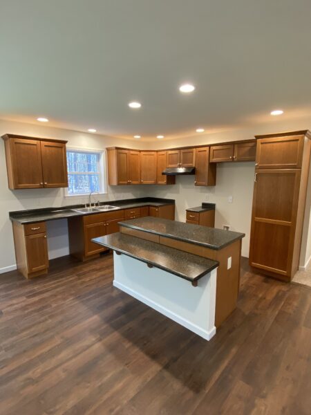 cherry kitchen with island in new modular ranch home project completed by Brookewood Builders, Manchester, ME 04351