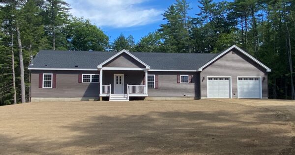 new custom modular ranch home project with porch and attached garage completed by Brookewood Builders, Manchester, ME 04351