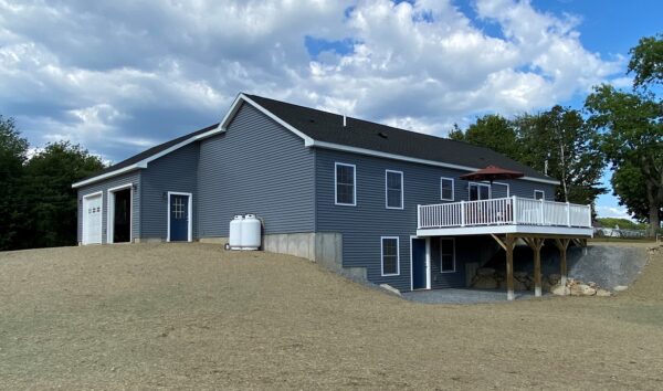 new custom modular ranch home project with attached garage deck and walk out basement completed by Brookewood Builders, Manchester, ME 04351
